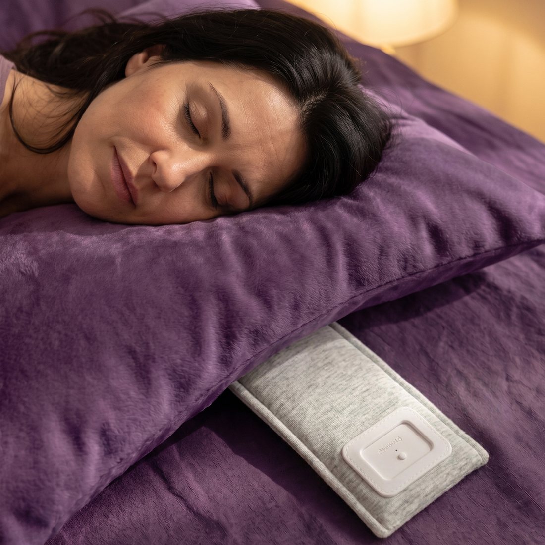 A woman asleep on her side, Drowsie peeking out from under her pillow